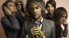 Wayne Coyne (center) with the rest of The Flaming Lips. Wayne Coyne (center) with the rest of The Flaming Lips.